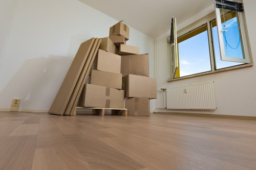 Packed household boxes and furniture prepared for a local move in Kennington