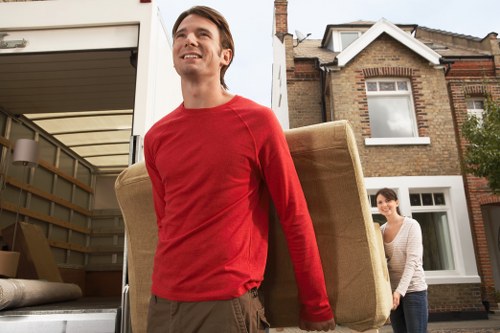 Packed moving boxes and furniture ready for a removal van in Kennington