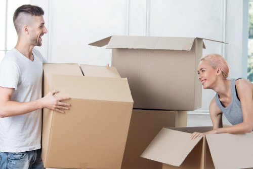 Careful handling of items through a narrow stairwell in a Kennington flat