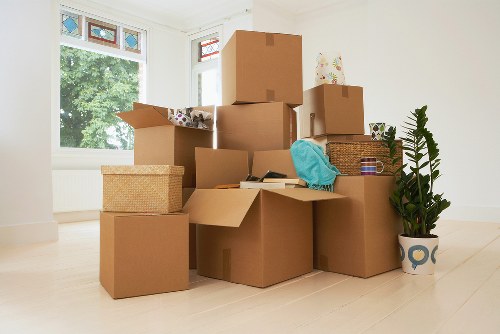Mover wearing PPE and handling boxes carefully