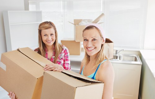 Household furniture being carried through a Kennington property